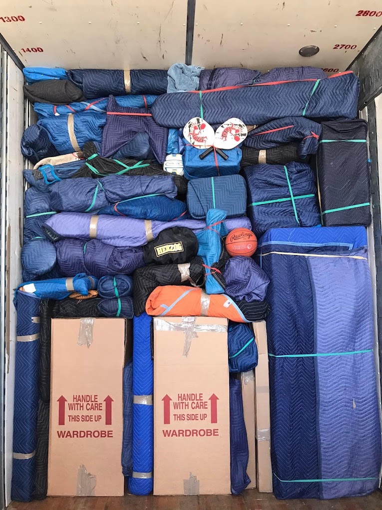 A moving truck packed with padded and secured household belongings